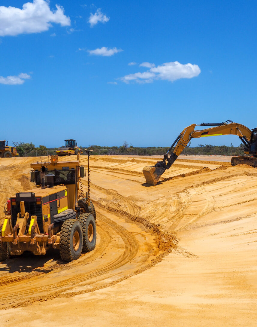 Grader and excavator shaping a landform at a mine rehabilitation site